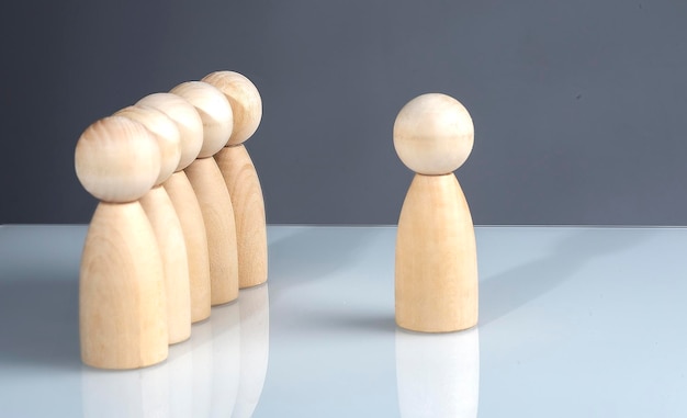 Successful business team leader concept: Wooden figures standing out from the crowd