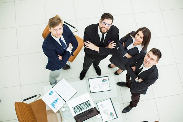 successful business team standing next to each other near the workplace in the office.