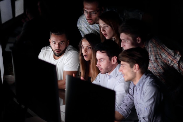 Successful business team in the workplace at night