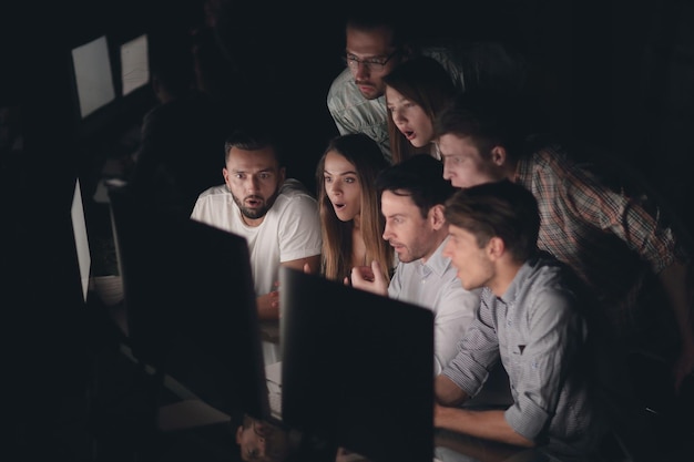 Successful business team in the workplace at nightphoto with copy space