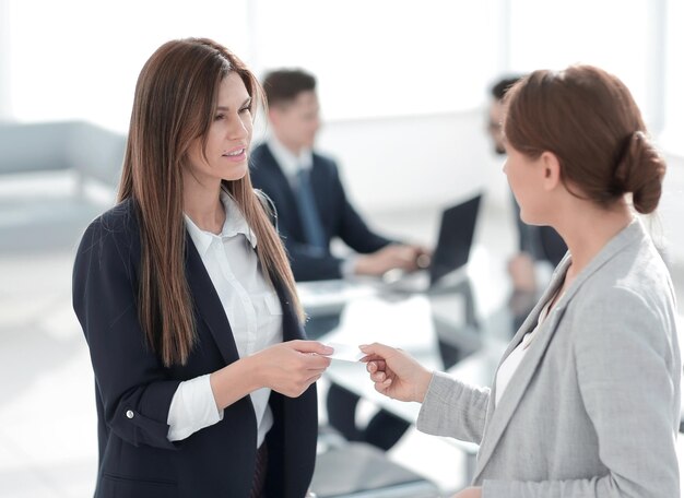 Successful business woman gives her business card business concept