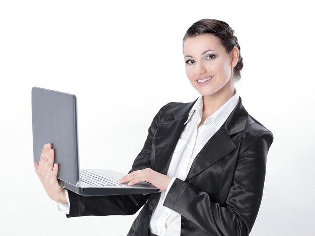 Successful business woman is standing with an open laptop