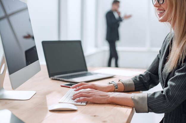 Successful business woman smiles at the clientsitting at the office table