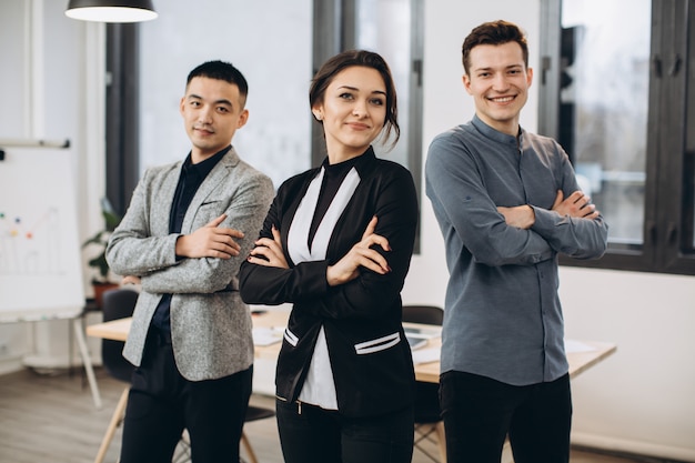 Successful business woman standing with her staff in at office