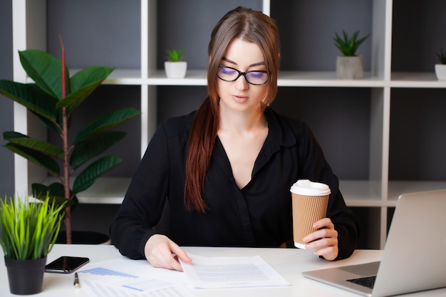 Successful business woman working at the computer in the office