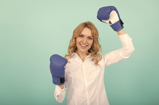 Successful businesslady in boxing gloves has business success ceo