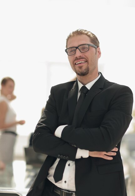 Successful businessman on the background of the office photo with copy space