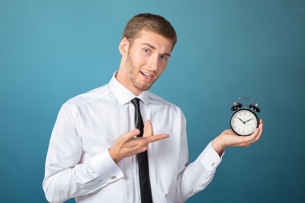 Successful businessman in formal wear pointing at clock 