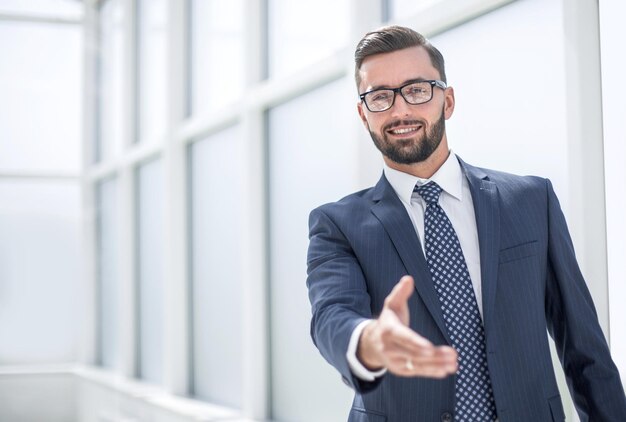 Successful businessman holding out his hand for a handshake