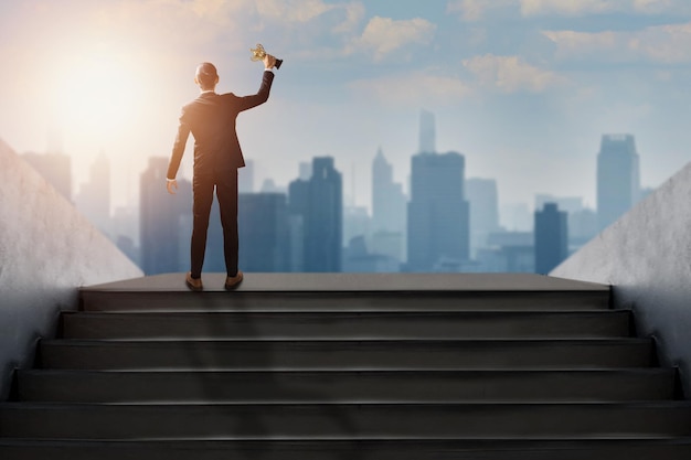 Photo successful businessman holding prize award trophy of success life and business, confidential achievement leader in suit get top of best goal step and show power of him