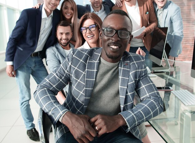 Successful businessman sitting in front of business team