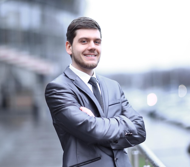 Successful businessman standing on the balcony of the office