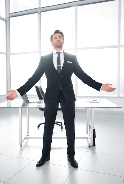 Successful businessman standing in his officephoto with copy space