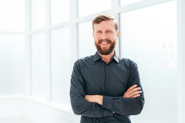 Successful businessman standing near the office window