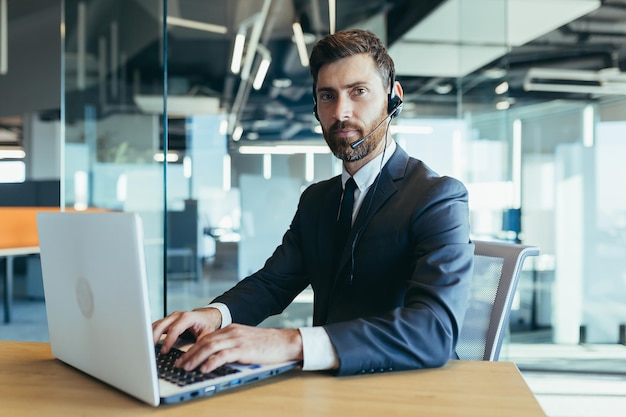 Successful businessman uses headset for online conference happy man smiling video call