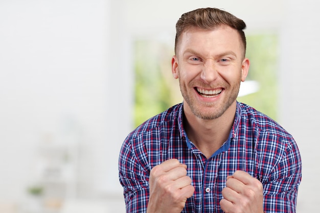 Successful businessman with arms up celebrating his victory