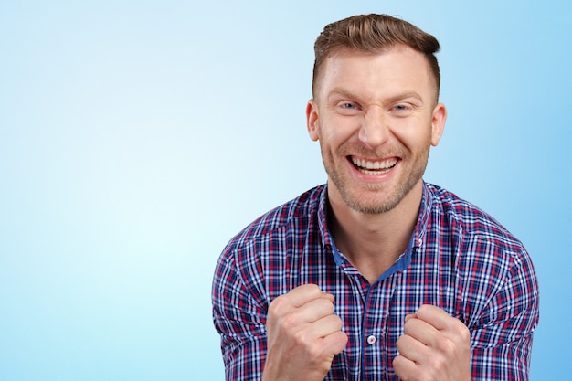 Successful businessman with arms up celebrating his victory