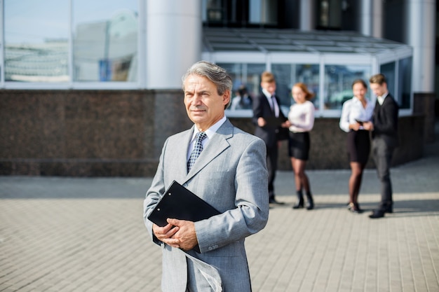 A successful businessman with documents on the background of the office