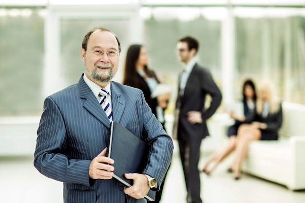 Photo successful businessman with documents on the wall of business team and office.