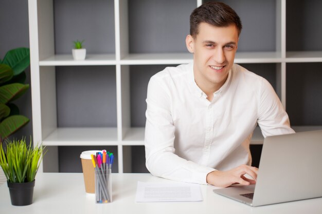 Successful businessman working in the office at the laptop