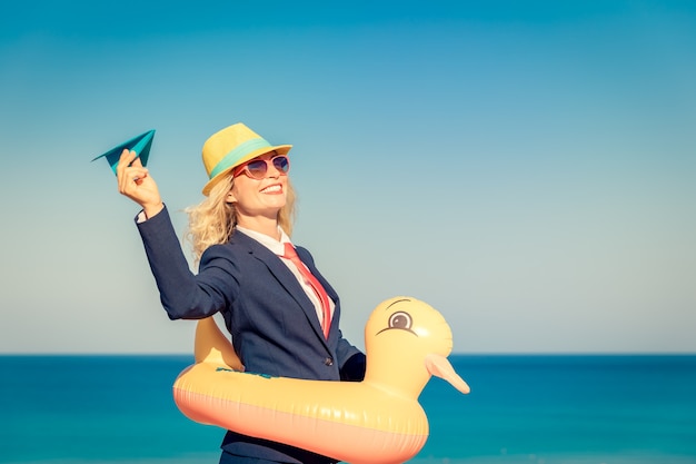 Successful businesswoman having fun on the beach Young woman against sea and sky