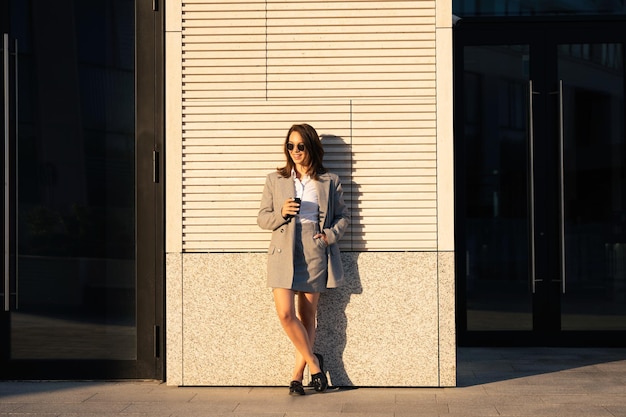 Successful businesswoman standing over modern office background startup and business concept