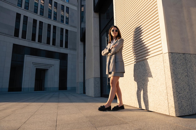 Successful businesswoman standing over modern office background startup and business concept