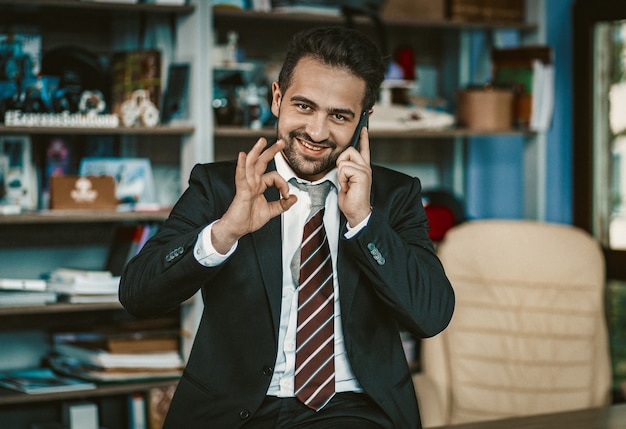 Successful Busy Business Man Shows Ok Using Phone