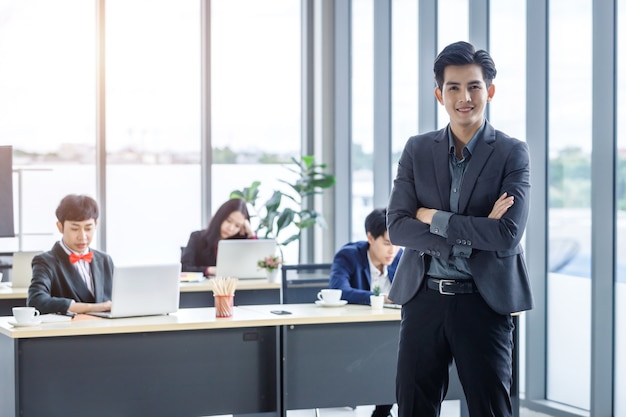 Successful company,executive Young Asian businessman partners with happy workers Group of asian business people with diverse genders (LGBT) in the meeting room at office