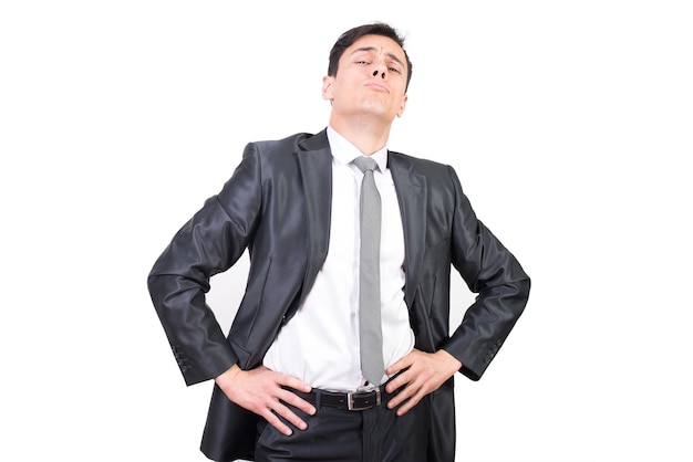 Successful confident male manager in classy suit standing with hands on waist while looking at camera on white background