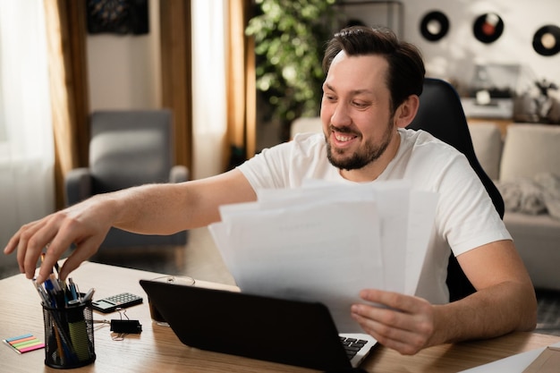 During successful deal with client successful man takes pen to sign the paper he smiles