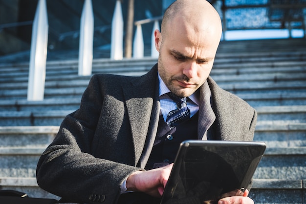 successful elegant fashionable businessman using tablet