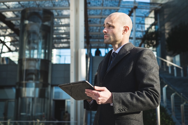 successful elegant fashionable businessman using tablet