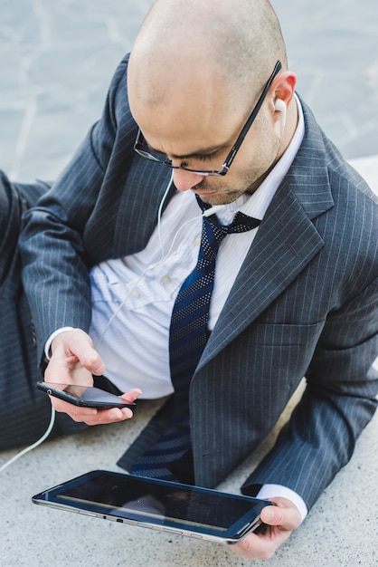 successful elegant fashionable businessman using tablet