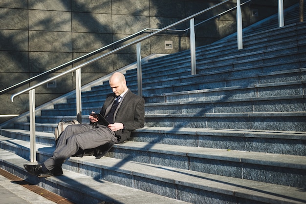 successful elegant fashionable businessman using tablet