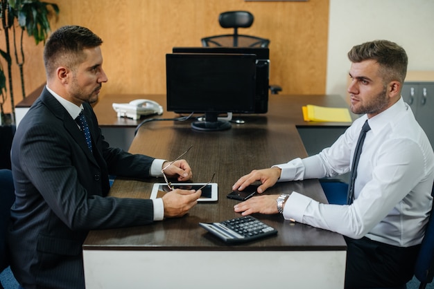 Successful employees in the office discuss new projects. Business, Finance