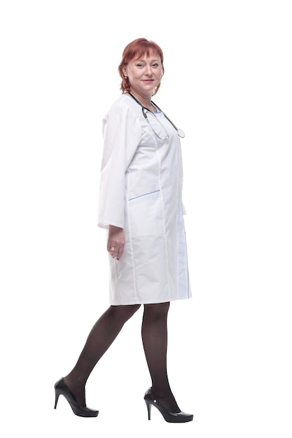 Successful female doctor with a stethoscope striding forward