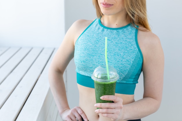 Successful fitness urban woman recommending detox smoothie