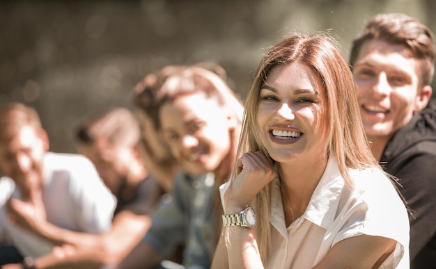 Successful girl on the background of her friends in the Park lifestyle