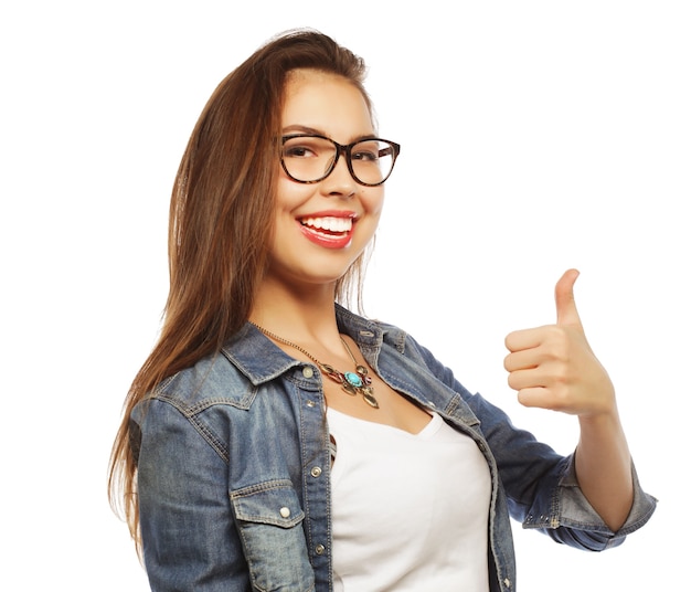 Successful happy girl gives thumb up with two hands