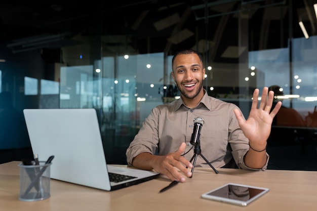 Successful hispanic businessman smiling and looking at camera portrait of satisfied man in middle of