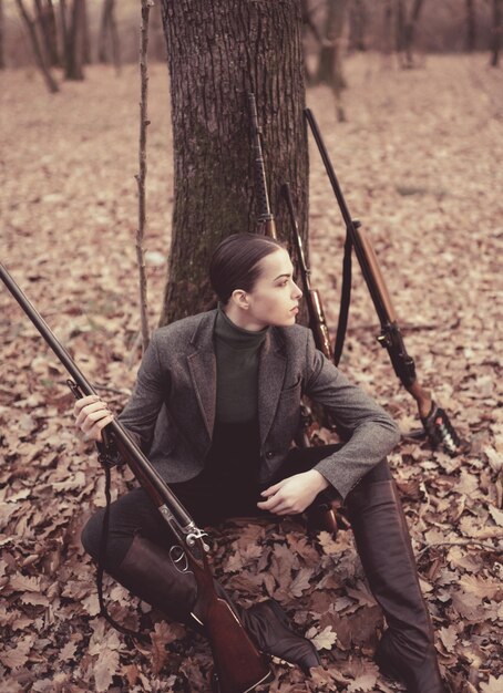 Successful hunt hunting sport woman with weapon Target shot girl with rifle chase hunting Gun shop female hunter in forest military fashion achievements of goals Hunting season