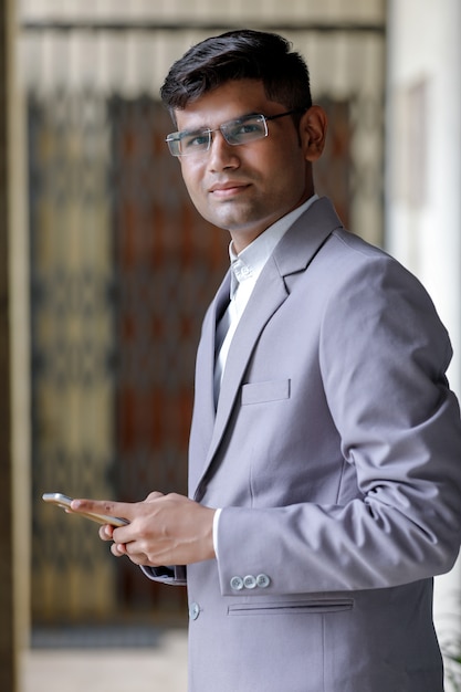 Successful Indian Businessman using smartphone