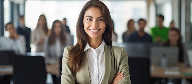 Successful Latin businesswoman smiling with crossed arms standing in a modern office