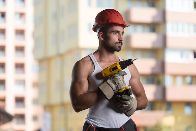 Successful Male Architect At A Building Site With Drill