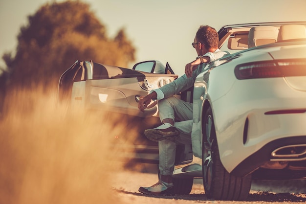 Successful Man Enjoying Sunset in His Cabriolet