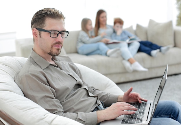 Successful man using a laptop in his living room