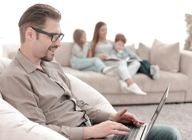 Successful man using a laptop in his living room