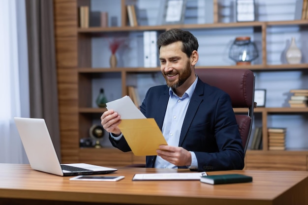 Successful mature man inside office at work senior man with beard in home office received mail fox