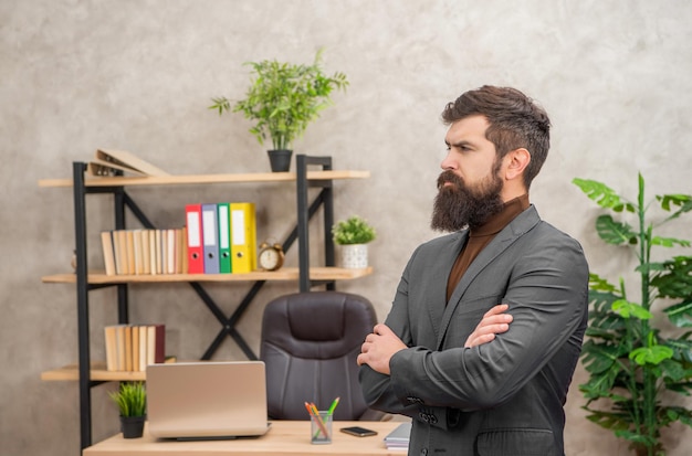 Successful mature man leader in jacket standing at office with copy space leadership